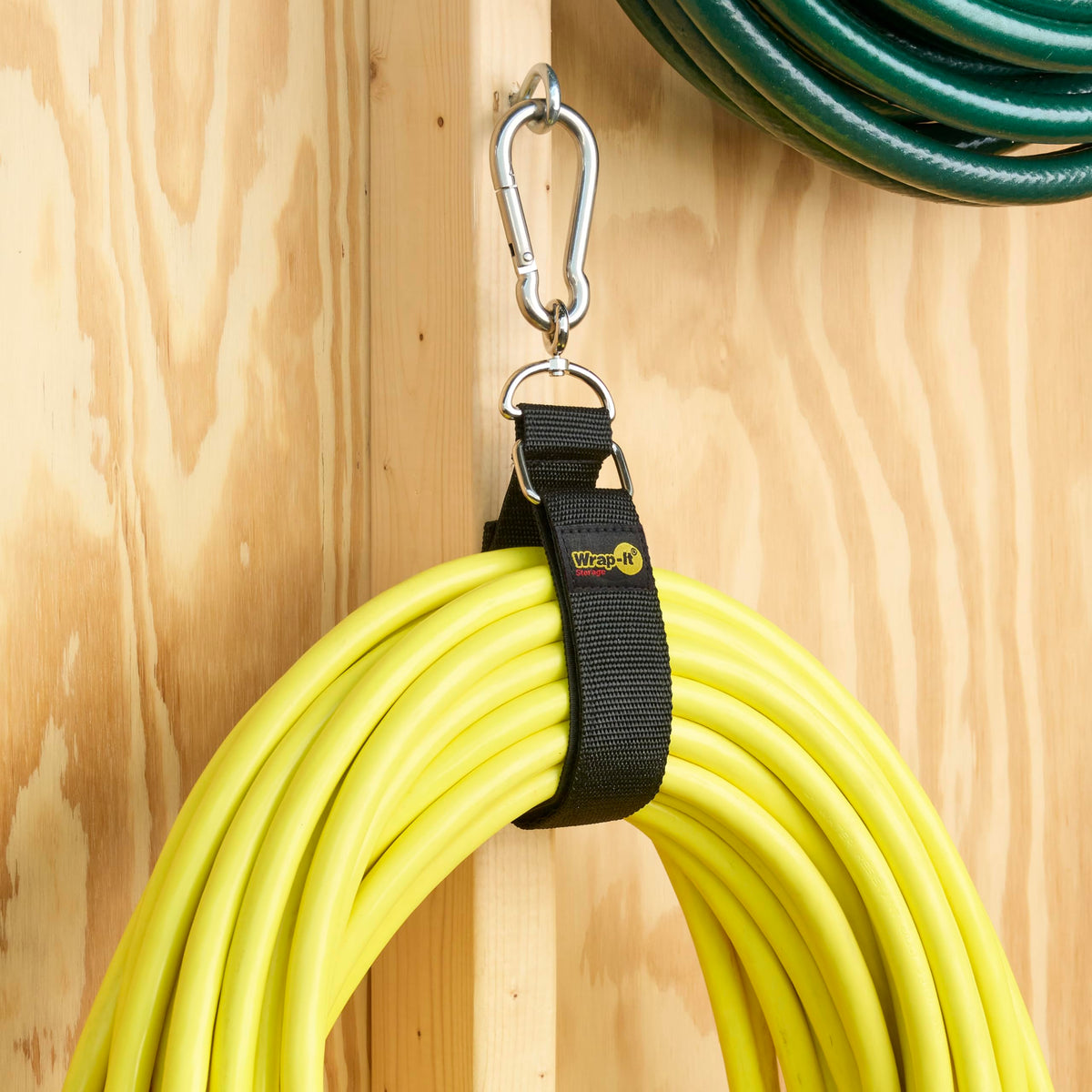 Hook 'n Hang attached to wall supporting ladder storage.