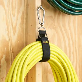 Hook 'n Hang attached to wall supporting ladder storage.