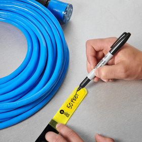 Wrap-It Storage straps bundling desk cables to reduce clutter and speed access