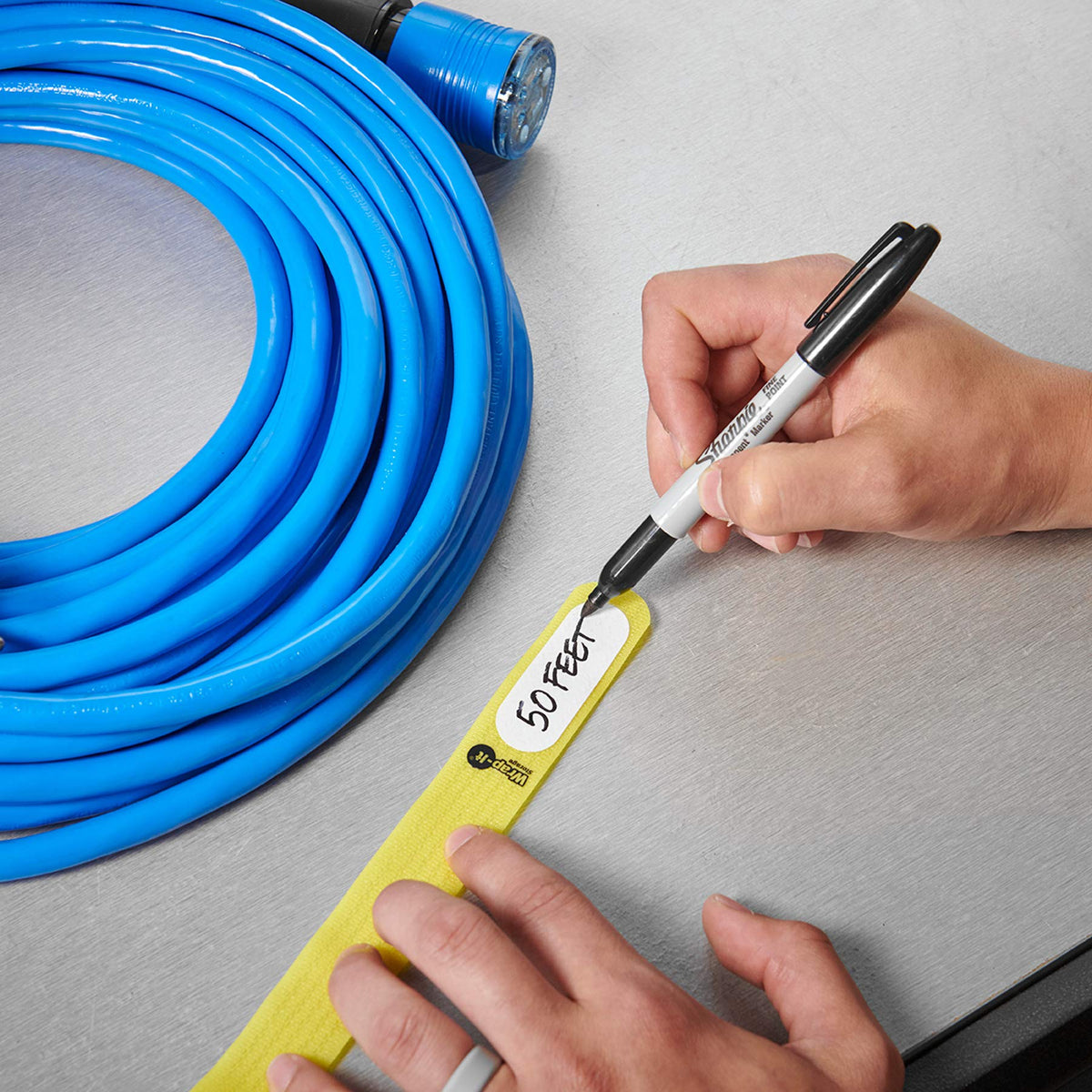 Wrap-It Storage Cinch-Straps used in a cable management angle for tidy workspace.