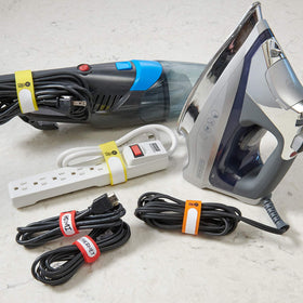 Wrap-It Storage Cinch-Straps in a garage scene bundling cords and tools.