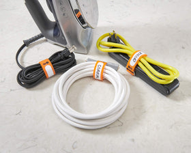 Wrap-It Storage cinch straps in the garage keep wires tidy.