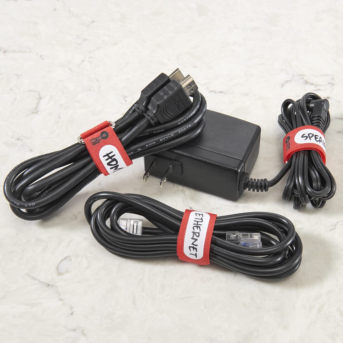 Wrap-It Storage Cinch-Straps metal buckle close-up showing secure reusable fastening.