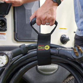Wrap-It Storage neatly coiled extension cords secured by straps for quick access benefit