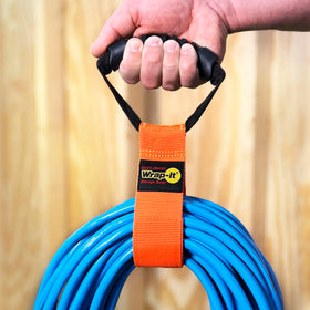 Handle-equipped Wrap-It Storage strap for carrying and hanging gear.