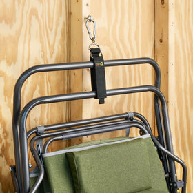 Wrap-It Storage holding a coiled extension cord on a garage peg, clearing floor space