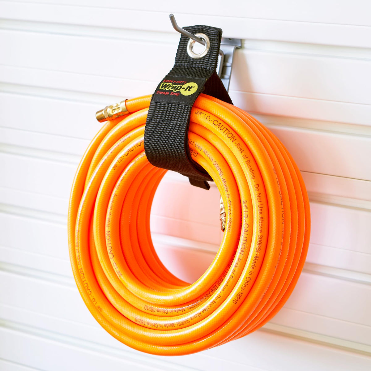 Wrap-It Storage multi-purpose strap for cords, hoses, and garden materials.