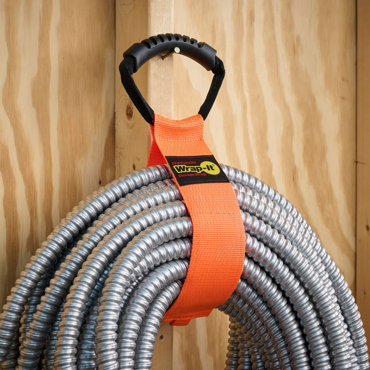 Wrap-It Storage Easy-Carry strap bundles garden hoses for tidy storage.