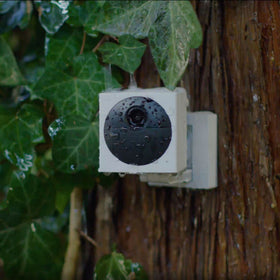 WYZE camera in hand showing small size for easy installation benefit
