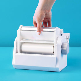Close-up of Xyron adhesive roll for precise edges on craft projects.