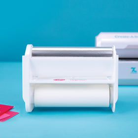 Xyron 5-inch Create-A-Sticker machine ready with refill for seamless sticker creation.