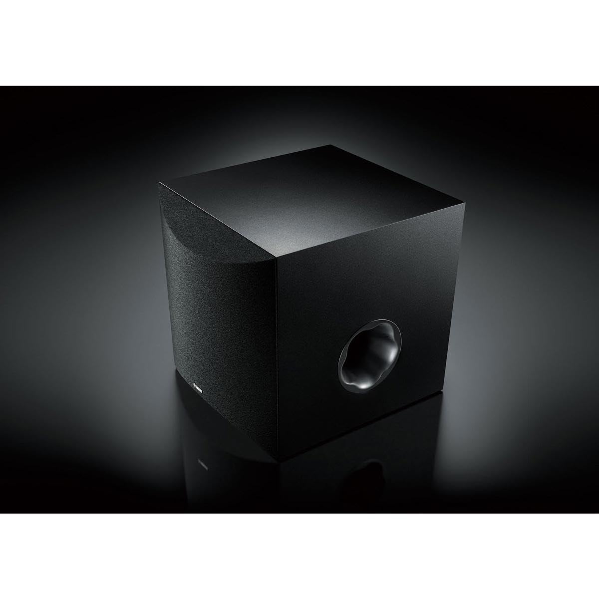 Yamaha NS-SW100BL subwoofer in room placement showing compact, stylish design.