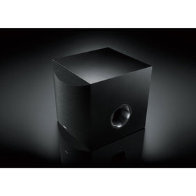Yamaha NS-SW100BL subwoofer in room placement showing compact, stylish design.