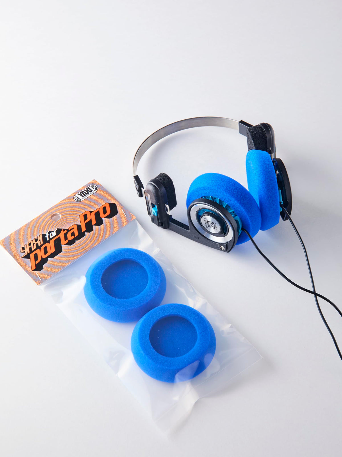 Top view shows improved seal with YAXI Porta Pro blue ear pads.