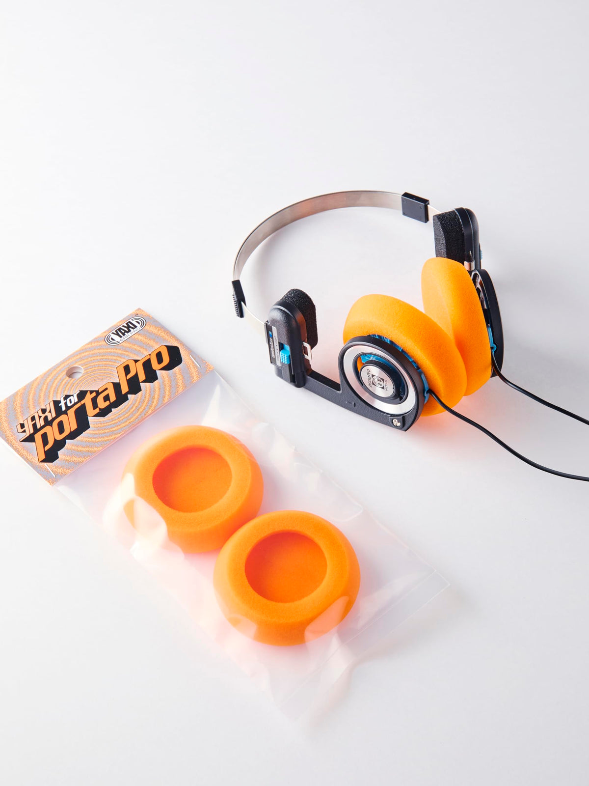 YAXI Porta Pro earpads orange on headphones demonstrates improved fit.