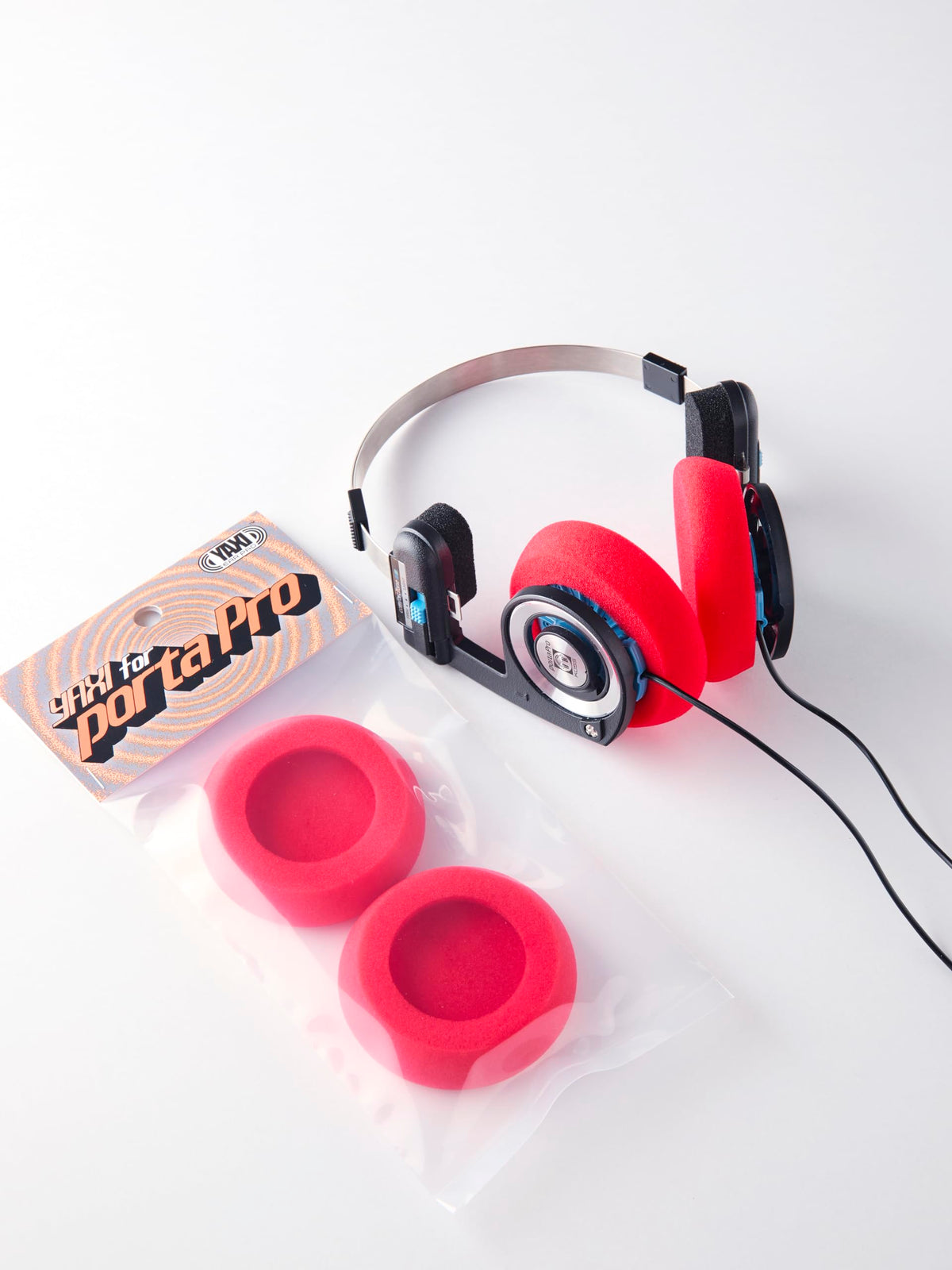 YAXI Porta Pro earpads red in-use angle for even clamp distribution.