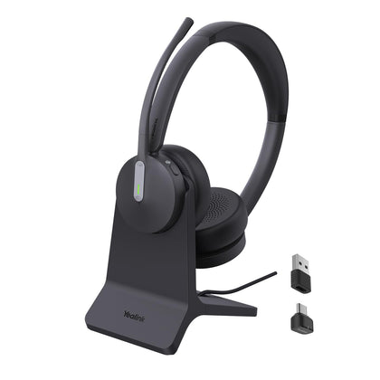 Yealink BH70 headset on desk with charging stand for clear calls.