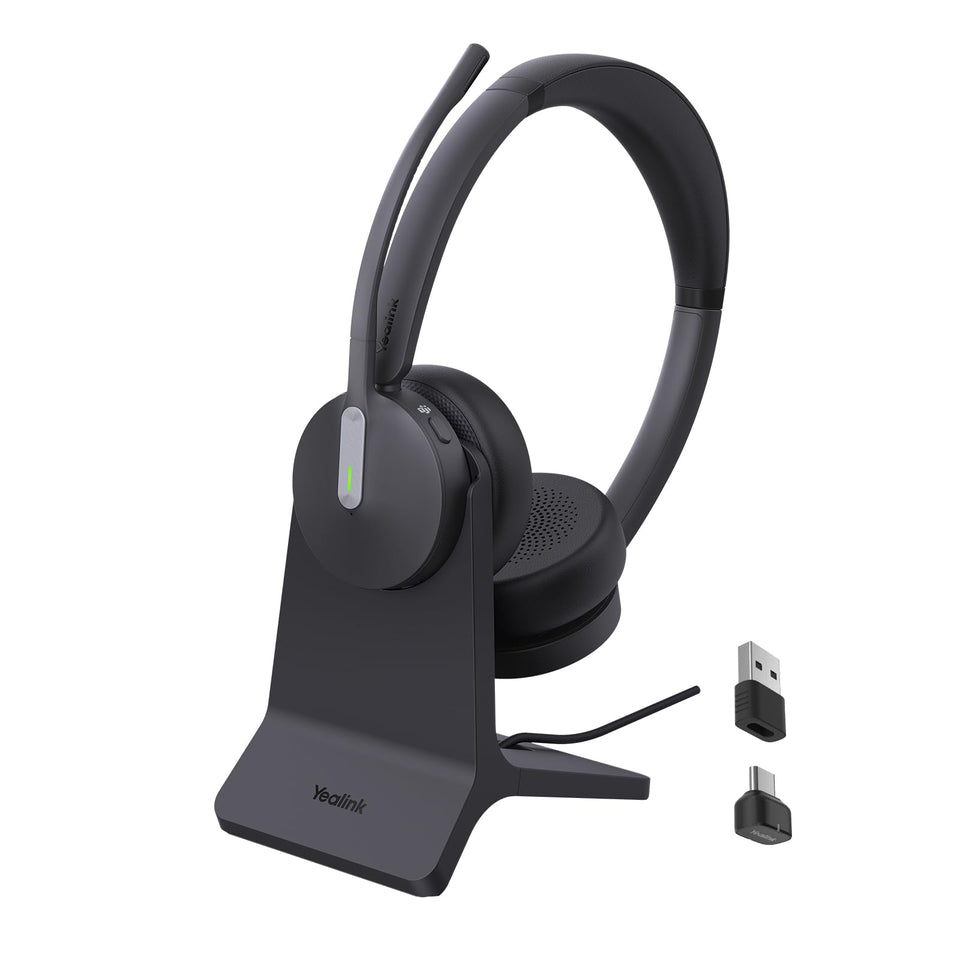 Yealink BH70 headset on desk with charging stand for clear calls.