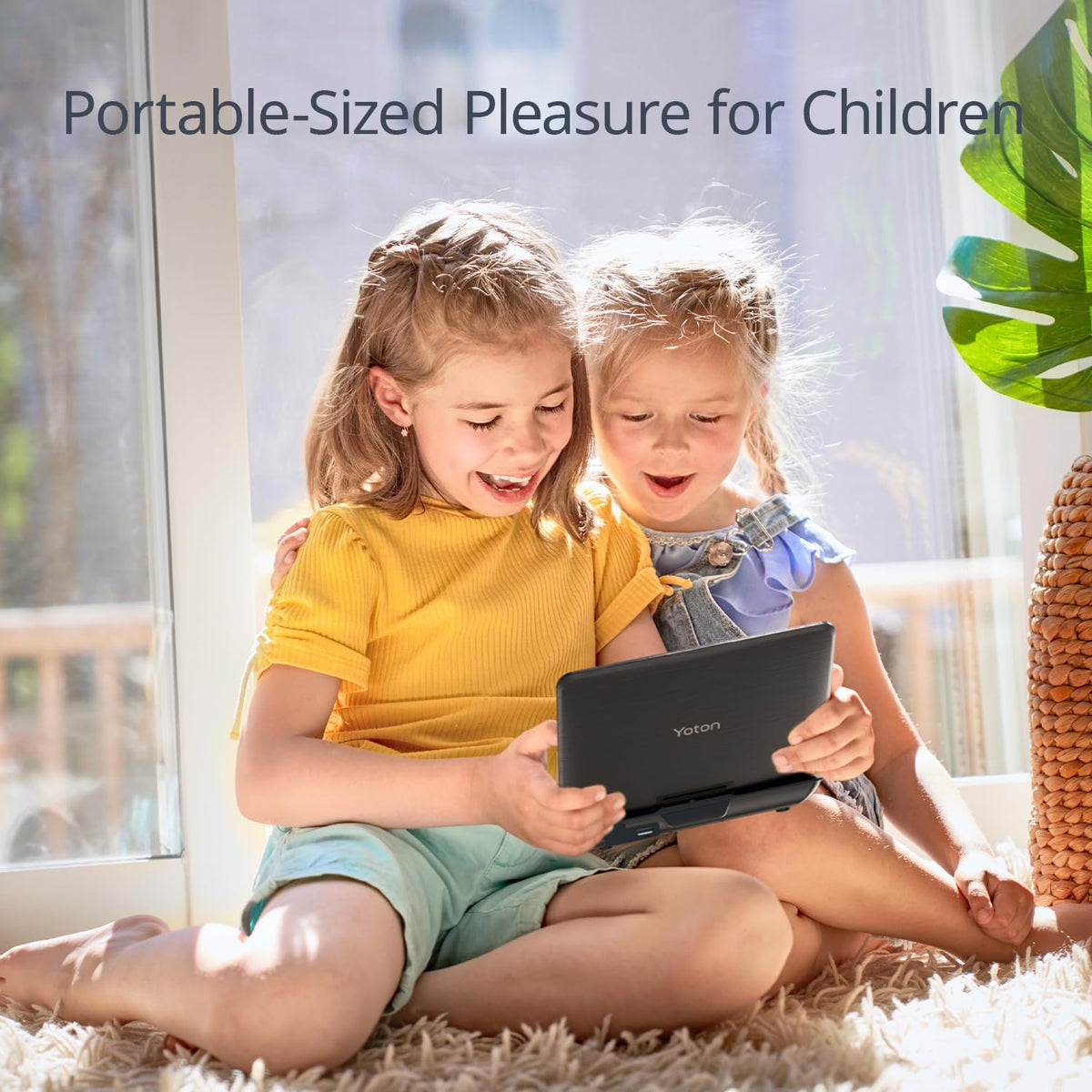 YOTON next to a child's hand to show portable size and convenient handling