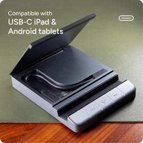 ZAGG hub beside laptop and phone showing compact scale and travel-ready design
